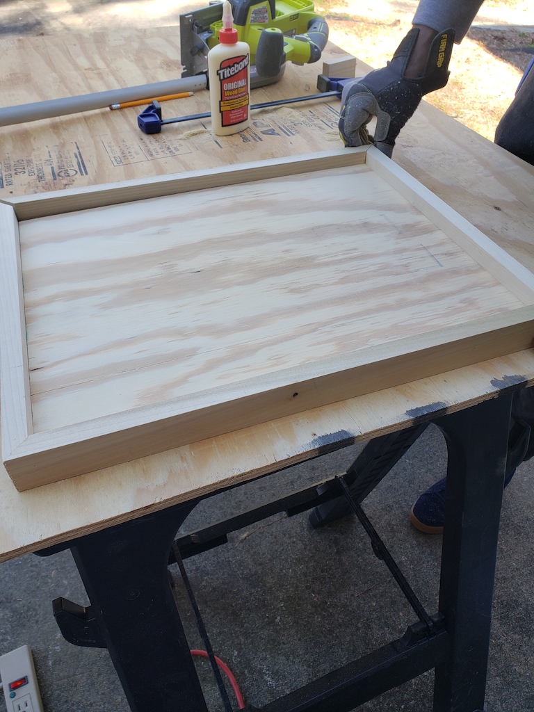 Tutorial for building a DIY Wooden Boot Tray, building the frame with a miter saw and attaching using wood glue